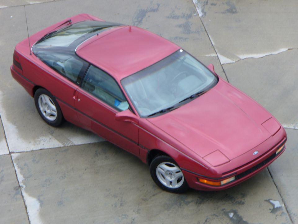 Red 1991 Ford Probe coupe with a glass roof, seen from above