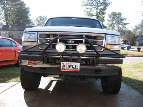 1994 Ford Bronco - White Ford truck with a black bull bar and auxiliary lights, seen from the front.