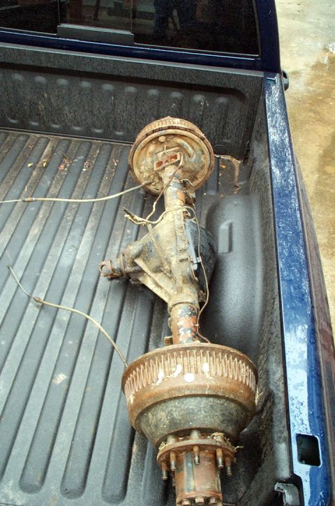 1978 Dodge Power Ram - Rear axle assembly with drum brakes, likely from a truck, is shown in the bed of a pickup.