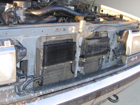 1989 Ford Bronco - Aftermarket transmission cooler mounted in the engine bay, obscuring the main radiator.