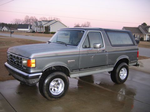 1989 Ford Bronco - This Ford Bronco is parked in a suburban driveway with houses in the background.