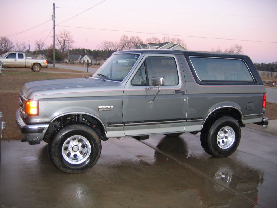 Side view of a gray 1989 Ford Bronco with a black top