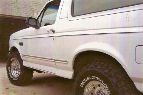 1995 Ford Bronco - This 1995 Ford Bronco is shown from a 3/4 front angle, highlighting its side profile and lifted suspension.