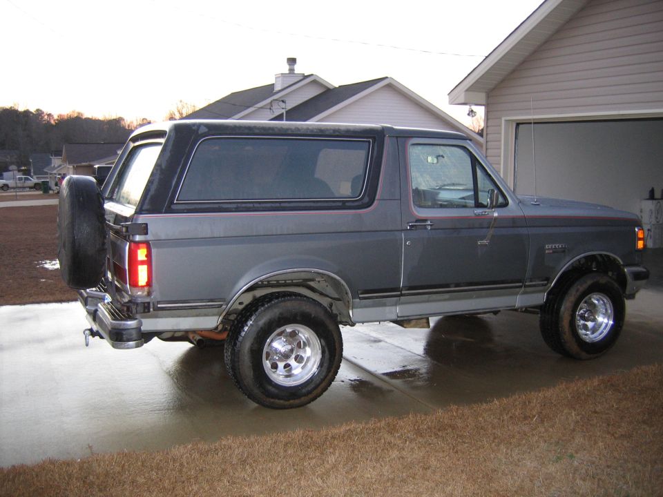 Gray 1989 Ford Bronco side view with spare tire on rear door
