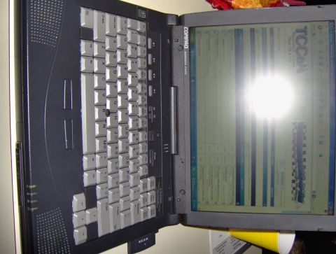 2004 Ford F-150 - A Compaq Armada laptop is open, showing a spreadsheet on its screen with the TCCAA logo visible.