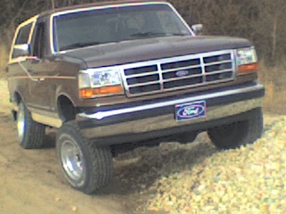 1992 Ford Bronco - on a rock pile from the front (look at the back tire)