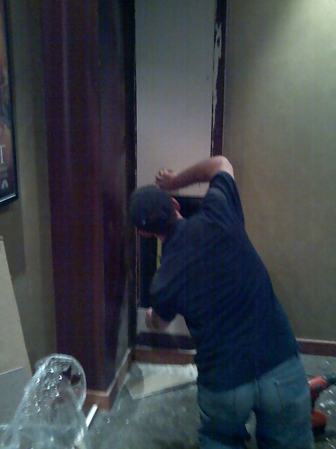 2006 Ford E350 - A person is actively working on a wall, with construction materials and tools visible around them.