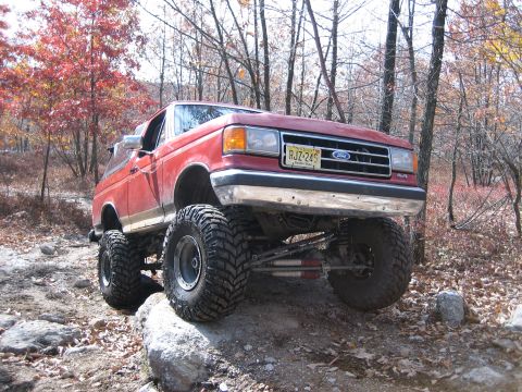 1990 Ford Bronco - This modified Ford Bronco navigates a rocky trail during autumn.