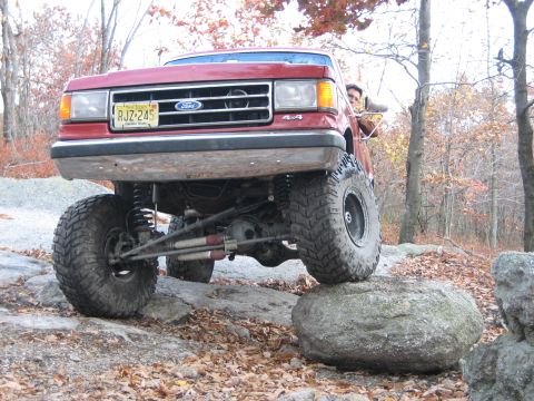 1990 Ford Bronco - This lifted 1990 Ford Bronco navigates rocky terrain, its off-road capabilities.