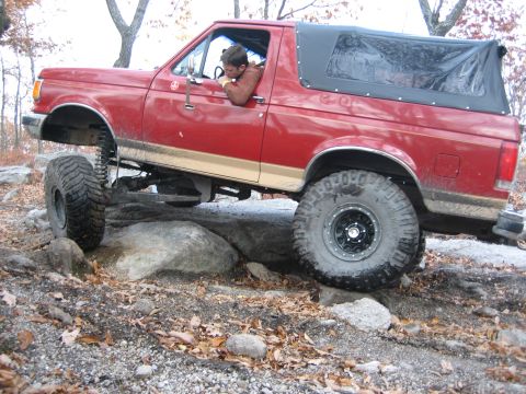1990 Ford Bronco - This modified 1990 Ford Bronco navigates a rocky trail, its off-road capabilities.