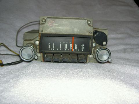 1967 Ford Ranchero - A vintage Ford car radio is shown, push buttons and a tuning dial with frequency markings.
