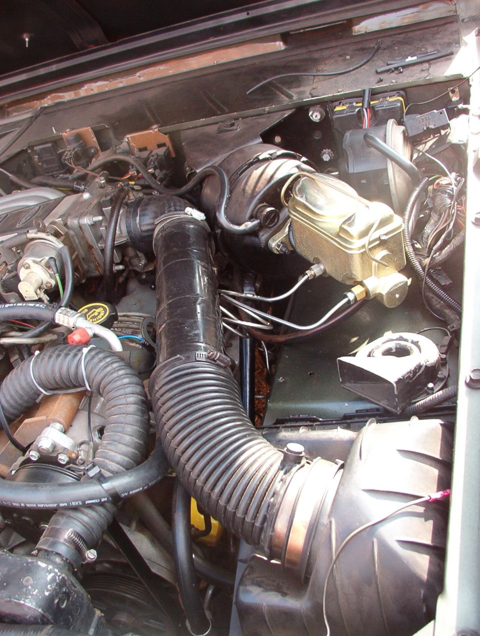 Engine bay detail showing brake master cylinder and wiring