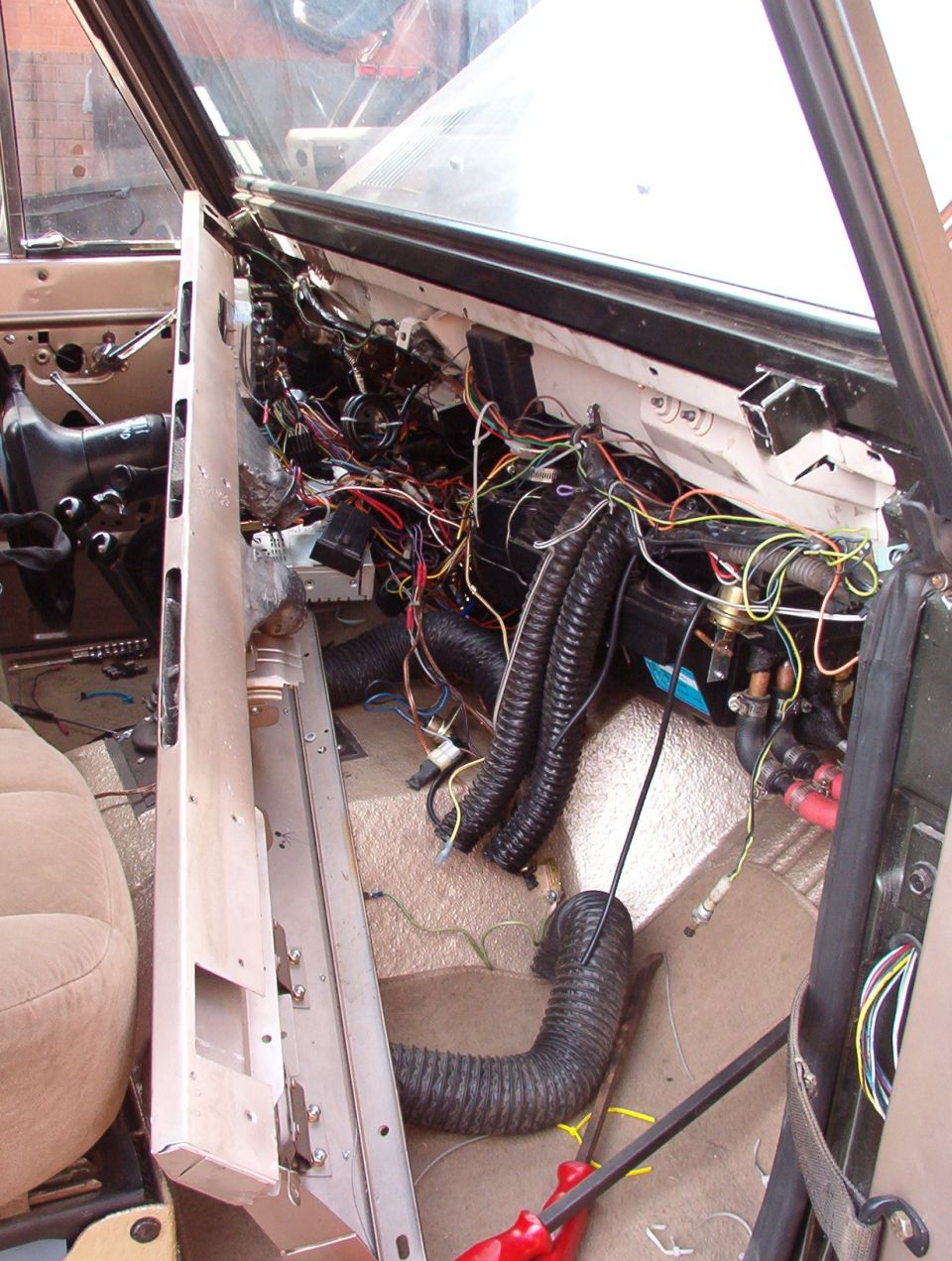 After those fixes, I also have to sort out this MESS.  The guy who installed the old dash (I was planning on building a totally new one) just zip-tied all the wires up, but he didn't bother to sort, untangle, arrange, or shorten them to fit.