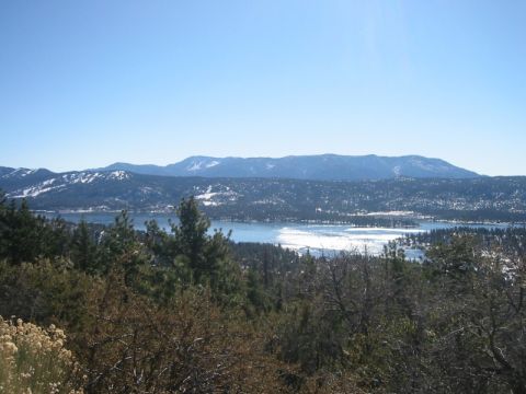 2000 Jeep Cherokee - A scenic view of a partially frozen lake surrounded by snow-dusted mountains and evergreen trees.