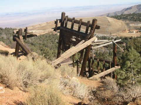 2000 Jeep Cherokee - An old wooden structure stands precariously on a dry, brush-covered hillside overlooking a vast, arid landscape.