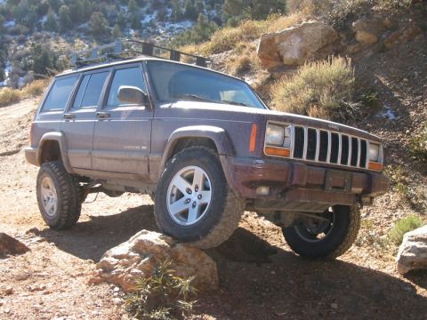 2000 Jeep Cherokee - Jeep Cherokee navigating a rocky off-road path with its front passenger side angled towards the camera.