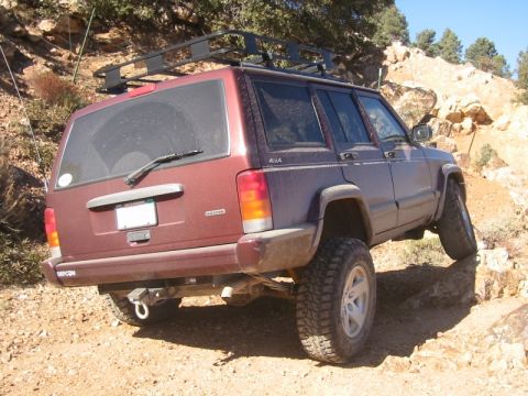 2000 Jeep Cherokee - This Jeep Cherokee is navigating a rough, rocky path, its off-road capabilities.