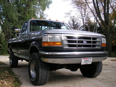 1992 Ford F-250 - This 1992 Ford F-250 pickup truck is shown in a three-quarter front view, a two-tone paint scheme and prominent chrome accents.