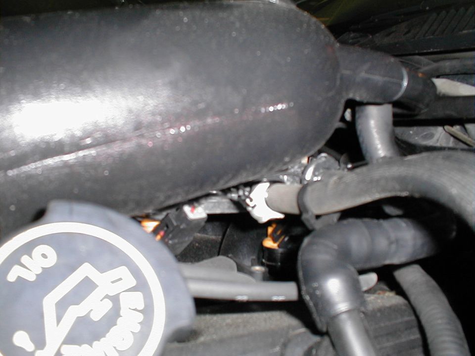 Engine intake manifold and hoses with oil cap visible