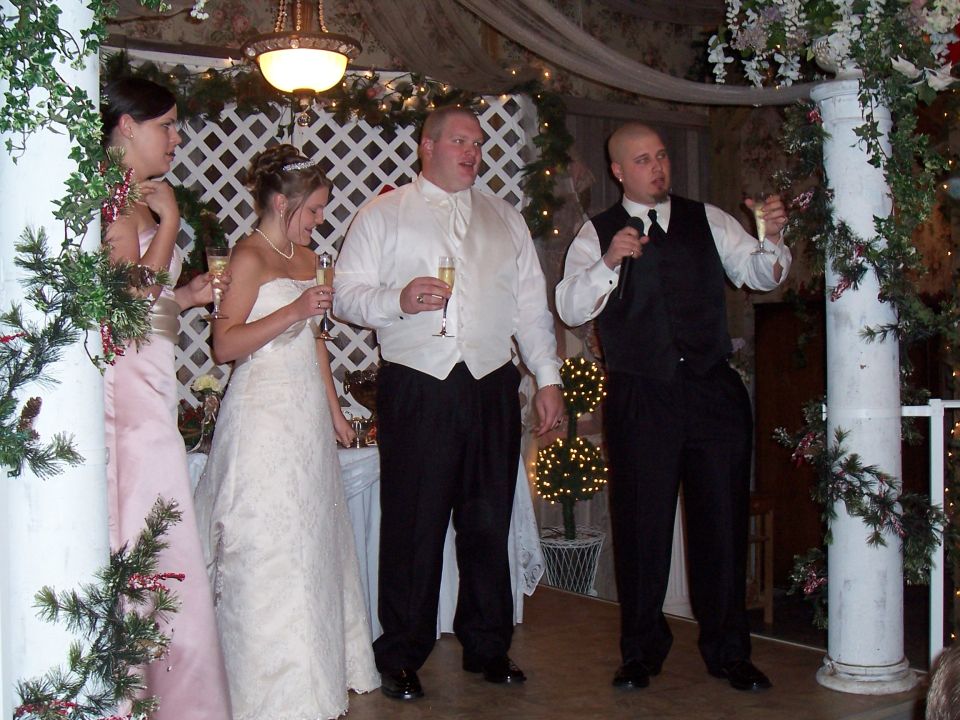 Wedding party with bride and groom holding champagne glasses