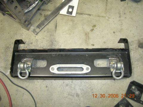 1996 Ford Bronco - Aftermarket winch bumper with D-ring tow hooks and winch mounting plate.