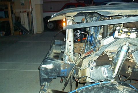 1986 Ford Bronco - A severely damaged vehicle front end is visible, with another vehicle in the background.