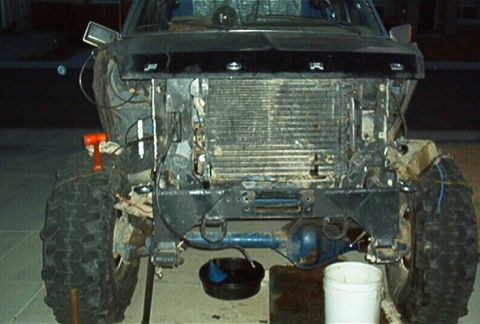 1986 Ford Bronco - Front end of a 1986 Ford Bronco disassembled for work, revealing the radiator and suspension.