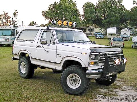 1986 Ford Bronco - White 1986 Ford Bronco modified for off-road use with a lift kit and large tires.