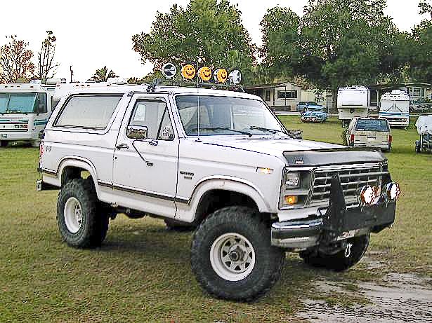 1986 Ford Bronco lifted with off-road tires and brush guard