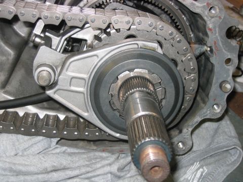 1992 Ford Bronco - Close-up of a disassembled transfer case interior showing the internal drive chain, planetary/sprocket teeth, and a splined output shaft pr…