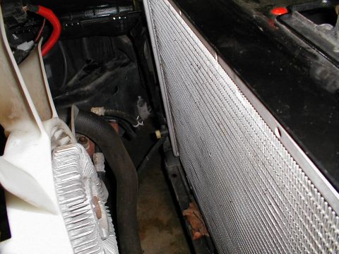1997 Ford Crown Victoria - Close-up of a vehicle's radiator and fan shroud, with Supermotors.net logo in the corner.