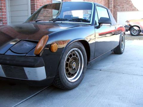 1974 Porsche 914 - Front quarter view of a black Porsche 914, with another vehicle in the background.