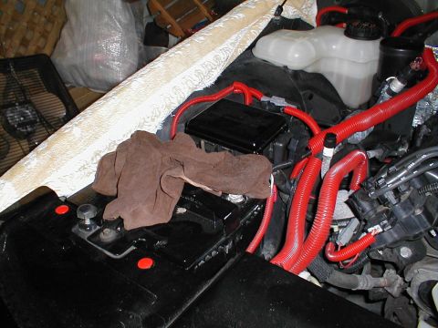 1997 Ford Crown Victoria - Close-up of an engine bay showing red wiring, battery, and a cloth. Supermotors.net logo is present.