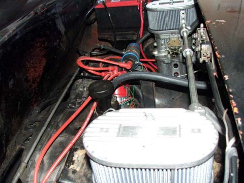 1974 Porsche 914 - Close-up of an engine bay with various components visible, including a carburetor and air filter.