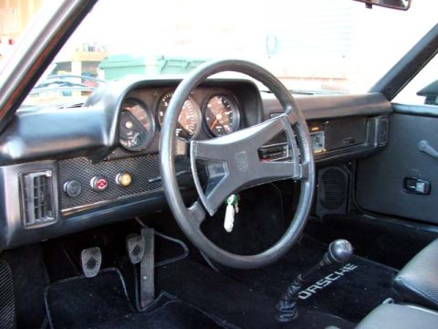 1974 Porsche 914 - The interior of a 1974 Porsche 914, viewed from the passenger side, highlights the dashboard and controls.
