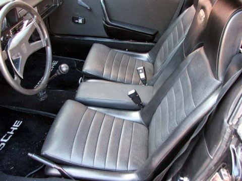 1974 Porsche 914 - The interior of a 1974 Porsche 914 features black perforated seats and matching floor mats with the Porsche logo.