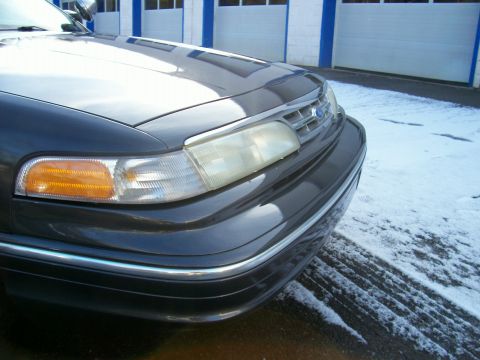 2001 Ford Crown Victoria - Close-up of the front corner of a Ford Crown Victoria, showing the headlight and grille area.