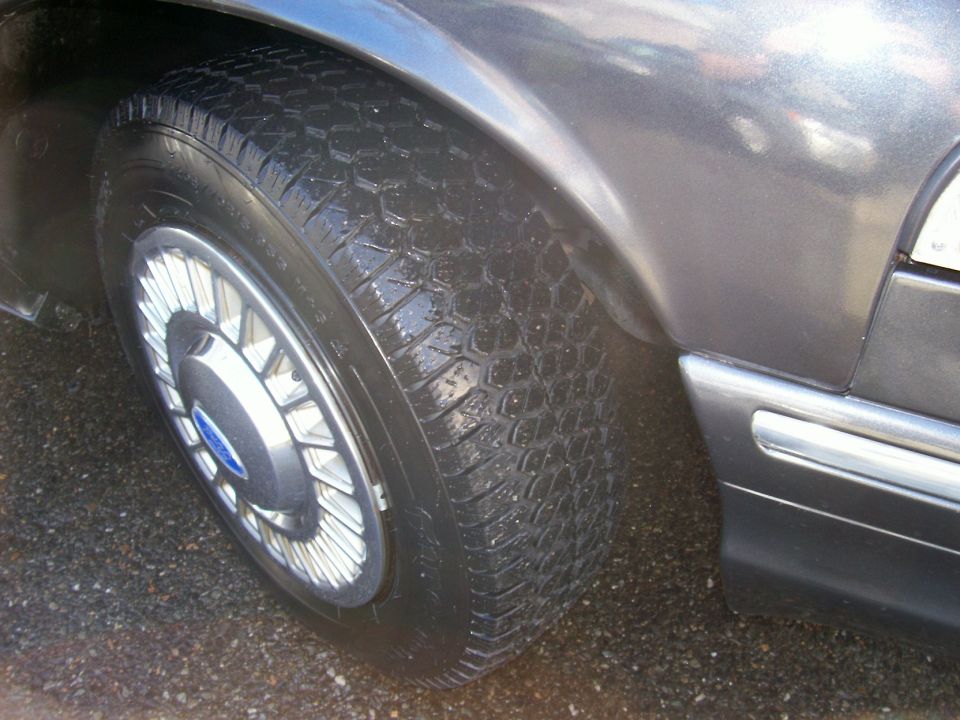 Close-up of a car's front passenger-side tire and fender