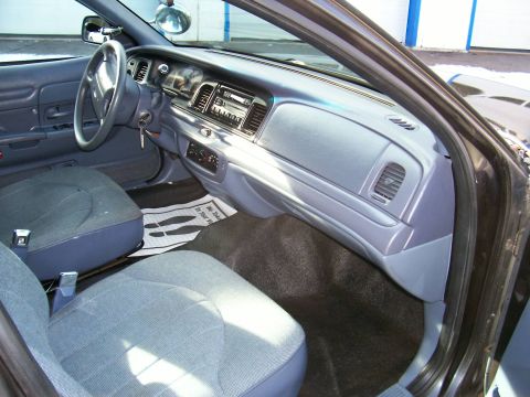 2001 Ford Crown Victoria - The interior of a 2001 Ford Crown Victoria is visible, with a focus on the dashboard and seating areas.