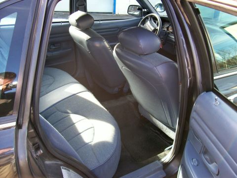 2001 Ford Crown Victoria - The interior of a 2001 Ford Crown Victoria, cloth seats and a view of the dashboard and steering wheel.