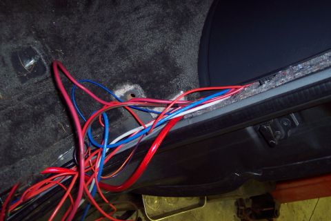 2002 Chevrolet Suburban - Vehicle interior with a mess of electrical wiring visible under the door sill and on the floor.