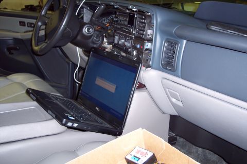 2002 Chevrolet Suburban - A laptop is connected to the dashboard of a 2002 Chevrolet Suburban for diagnostics.