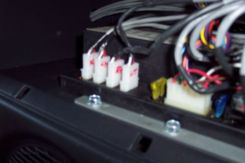 2002 Chevrolet Suburban - A close-up view shows several white electrical connectors with red wire leads, along with fuses and a thick bundle of wires.
