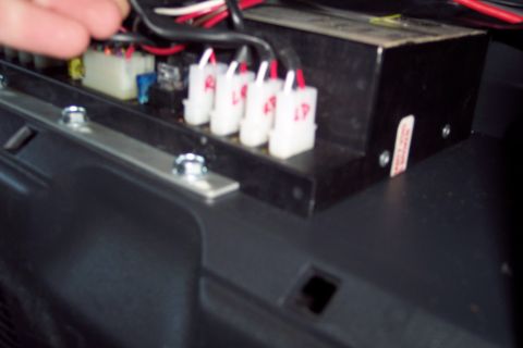 2002 Chevrolet Suburban - Close-up view of a vehicle's interior wiring harness and electronic module with labeled connectors.