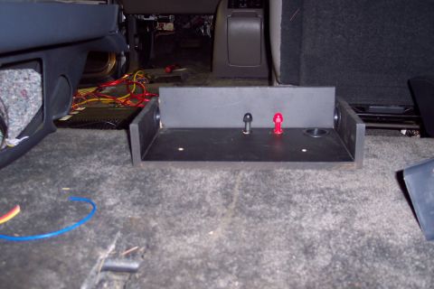 2002 Chevrolet Suburban - Custom subwoofer box installed in a vehicle, showing wiring and terminal posts.