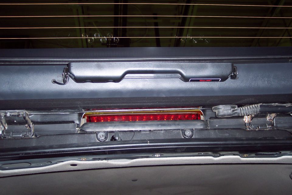 2002 Chevrolet Suburban third brake light assembly with red LEDs and black housing, viewed from interior rear