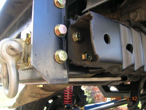 1996 Ford Bronco - This photo shows a close-up of a vehicle's tow hitch mounting bracket and hardware.