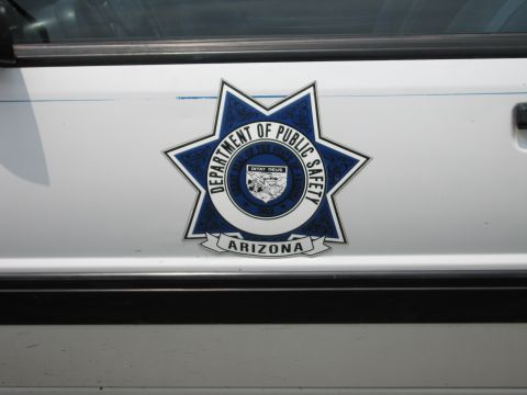 1991 Ford LTD Crown Victoria - Close-up of an Arizona Department of Public Safety seven-point star badge decal on the white door of a vehicle.
