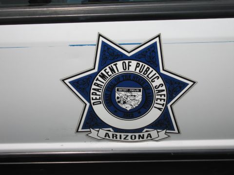 1991 Ford LTD Crown Victoria - Detailed close-up of the blue-and-white Arizona Department of Public Safety star emblem decal on a white vehicle door.