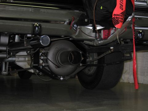 1991 Ford LTD Crown Victoria - low-angle view of a car's rear axle, exhaust outlet and red drag parachute pack with a Remove Before Run streamer.